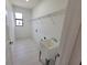 Bright laundry room with white cabinets and sink at 5115 Foxhall Rd, North Port, FL 34288