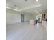 Spacious living room connects to an open kitchen with an island, modern lighting, and sleek flooring at 5115 Foxhall Rd, North Port, FL 34288