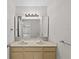 Bright bathroom featuring a double sink vanity and mirrored medicine cabinets for ample storage at 5122 Marsh Field Rd # 62, Sarasota, FL 34235