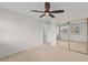 Bedroom featuring neutral carpet, ceiling fan and sliding mirrored closet doors at 5122 Marsh Field Rd # 62, Sarasota, FL 34235