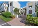 Well maintained building exterior featuring clean stucco, brick entryway, and lush landscaping at 5122 Marsh Field Rd # 62, Sarasota, FL 34235
