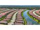 Community aerial view showcasing winding waterway, manicured landscaping and consistent tiling on roofs of homes at 5388 Bartolomeo St, Sarasota, FL 34238