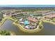 Aerial view showcasing the community pool, clubhouse, tennis courts, and surrounding lakes at 5388 Bartolomeo St, Sarasota, FL 34238