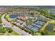 Aerial view of the community clubhouse, pool, tennis courts, and surrounding homes at 5388 Bartolomeo St, Sarasota, FL 34238