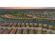 Aerial view of a neighborhood with lake, showcasing the tiled roofs, lush landscaping, and community layout at 5388 Bartolomeo St, Sarasota, FL 34238
