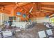 Open-air bar area with high ceilings, TVs, ceiling fans, and a variety of seating options, ideal for relaxation at 5388 Bartolomeo St, Sarasota, FL 34238