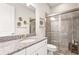Elegant bathroom features a glass-enclosed shower and a granite-topped vanity at 5388 Bartolomeo St, Sarasota, FL 34238