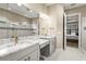 Bright bathroom featuring double vanity with granite countertops and decorative mirrors and lighting at 5388 Bartolomeo St, Sarasota, FL 34238