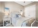 Cozy bedroom with soft lighting, patterned bedding, and coastal themed decorations at 5388 Bartolomeo St, Sarasota, FL 34238