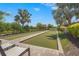 Bocce ball court area with lounge chairs, palm trees, and manicured landscaping at 5388 Bartolomeo St, Sarasota, FL 34238