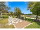 Community outdoor chess board surrounded by lush landscaping and a pond at 5388 Bartolomeo St, Sarasota, FL 34238
