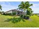 Expansive backyard of this home featuring a large lawn and screened lanai at 5388 Bartolomeo St, Sarasota, FL 34238