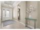 Bright foyer features tiled floor, an ornate chandelier and glass adorned front door at 5388 Bartolomeo St, Sarasota, FL 34238