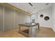 Bright game room features wood floors, a ping pong table, and modern lighting at 5388 Bartolomeo St, Sarasota, FL 34238