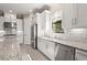 Bright kitchen featuring white cabinets, stainless steel appliances, and granite countertops at 5388 Bartolomeo St, Sarasota, FL 34238