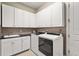 Well-equipped laundry room with modern washer and dryer, plus ample cabinet space at 5388 Bartolomeo St, Sarasota, FL 34238