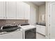Spacious laundry area with modern appliances and generous storage cabinets at 5388 Bartolomeo St, Sarasota, FL 34238