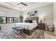 Bedroom featuring a large window with lake views and stylish decor at 5388 Bartolomeo St, Sarasota, FL 34238