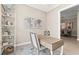 Well-lit office space with a modern desk and a view into an adjacent dining area at 5388 Bartolomeo St, Sarasota, FL 34238