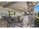 Inviting outdoor lounge area with comfortable seating, stylish ceiling fans, and scenic views of the surrounding landscape at 5388 Bartolomeo St, Sarasota, FL 34238