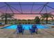 Enjoy the serene views from this beautiful pool area, complete with comfortable blue lounge chairs at 5388 Bartolomeo St, Sarasota, FL 34238