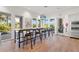 Open concept resident lounge with long bar height table and chairs, natural lighting and modern stainless steel appliances at 5388 Bartolomeo St, Sarasota, FL 34238