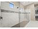 Bright walk-in shower featuring marble tile and shower head with glass surround at 5388 Bartolomeo St, Sarasota, FL 34238