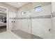 Spacious walk-in shower featuring gray mosaic tile stripe and glass surround at 5388 Bartolomeo St, Sarasota, FL 34238