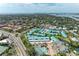 Coastal community aerial view featuring boat docks, tennis courts, and swimming pool at 5631 Midnight Pass Rd # 1007, Sarasota, FL 34242