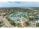 Wide aerial shot of coastal community with pool, tennis courts, and boat docks at 5631 Midnight Pass Rd # 1007, Sarasota, FL 34242