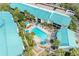 Overhead shot of community pool with lounge chairs and umbrellas at 5631 Midnight Pass Rd # 1007, Sarasota, FL 34242