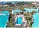 Aerial view of community highlighting pool, landscaping, and teal roofs at 5631 Midnight Pass Rd # 1007, Sarasota, FL 34242