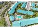 Aerial view of the condo complex featuring a swimming pool and ample parking at 5631 Midnight Pass Rd # 1007, Sarasota, FL 34242