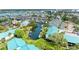 Aerial view of waterfront property with boat docks, lush landscaping, and serene canal at 5631 Midnight Pass Rd # 1007, Sarasota, FL 34242