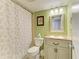 Charming bathroom with green walls, vanity with storage, and a shower-tub combo, offering functionality at 5631 Midnight Pass Rd # 1007, Sarasota, FL 34242