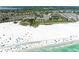 Scenic view of a beach with ocean waves, beachgoers, and cityscape at 5631 Midnight Pass Rd # 1007, Sarasota, FL 34242