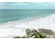 Scenic beach with white sands, clear water, and colorful beach umbrellas at 5631 Midnight Pass Rd # 1007, Sarasota, FL 34242