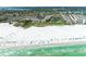 Panoramic view of beach and community, with white sand, turquoise water, and lush greenery at 5631 Midnight Pass Rd # 1007, Sarasota, FL 34242