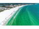 Aerial view of a beach with a cityscape backdrop and turquoise ocean at 5631 Midnight Pass Rd # 1007, Sarasota, FL 34242
