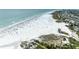 Expansive beachfront scene featuring white sand, ocean views, and beachgoers at 5631 Midnight Pass Rd # 1007, Sarasota, FL 34242