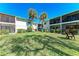 Exterior view of the building and manicured lawn at 5631 Midnight Pass Rd # 1007, Sarasota, FL 34242
