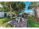 Outdoor common area with stone picnic table and grills at 5631 Midnight Pass Rd # 1007, Sarasota, FL 34242