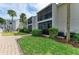 Building exterior with well-kept lawns and paved walkway, in a peaceful residential area at 5631 Midnight Pass Rd # 1007, Sarasota, FL 34242