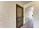 Condo front door with screen and lock, offering privacy and security in a quiet community at 5631 Midnight Pass Rd # 1007, Sarasota, FL 34242
