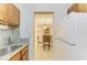 Galley kitchen next to dining area with updated countertops and stainless steel faucet at 5631 Midnight Pass Rd # 1007, Sarasota, FL 34242