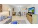 Open-concept living and dining area with tile flooring and bright decor at 5631 Midnight Pass Rd # 1007, Sarasota, FL 34242