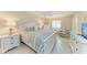 Cozy main bedroom with a ceiling fan, and large window, offering natural light and serene relaxation at 5631 Midnight Pass Rd # 1007, Sarasota, FL 34242