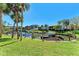 Waterfront views of the canal with boat docks, surrounded by palm trees at 5631 Midnight Pass Rd # 1007, Sarasota, FL 34242