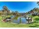 Beautiful waterfront view with private docks, palm trees, and well-maintained green spaces at 5631 Midnight Pass Rd # 1007, Sarasota, FL 34242