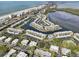 Aerial view of the community with a swimming pool and docks leading to the bay at 565 Sutton Place, Longboat Key, FL 34228